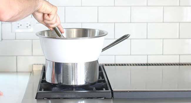 whisking curd in a double boiler