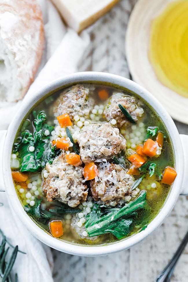 a bowl of italian soup with meatballs and vegetables