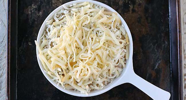 shredded cheese in a casserole dish