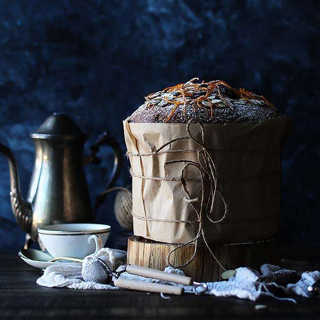 Chocolate and Orange Panettone Recipe wrapped in parchment paper with coffee