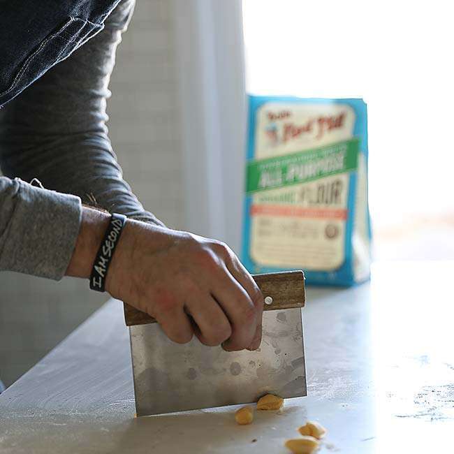 making individual little dough balls with a bench knife