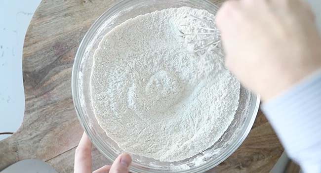 whisking flour in a bowl