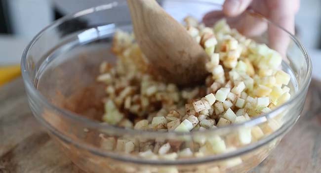 mixing apples and spices together