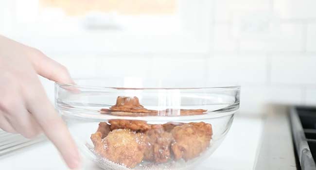 tossing apple fritters with cinnamon and sugar