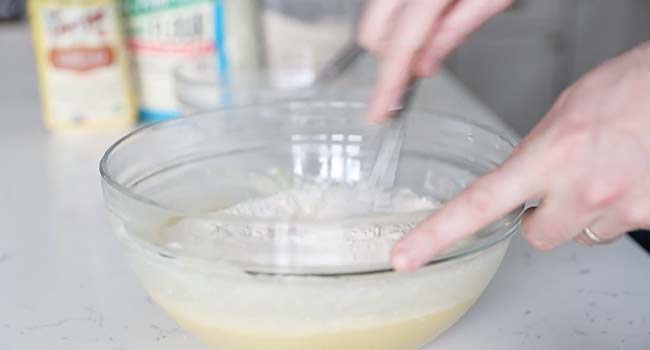 whisking flour with eggs