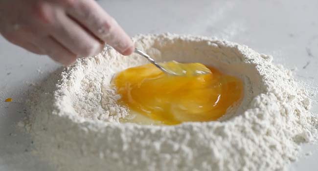 mixing flour with eggs 