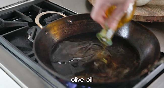 adding oil to a pan