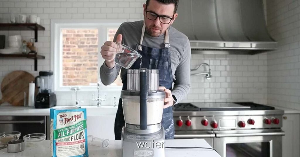 adding water to a pie dough