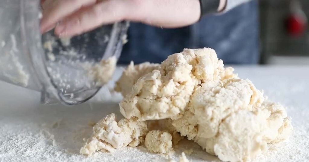 transferring a pie dough to a clean surface with flour