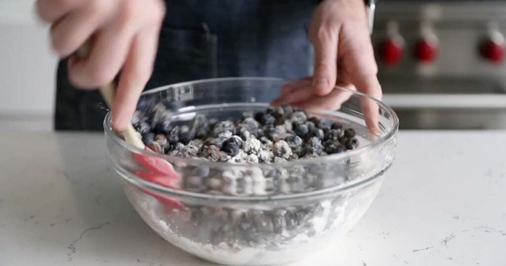 mixing together blueberries and spices