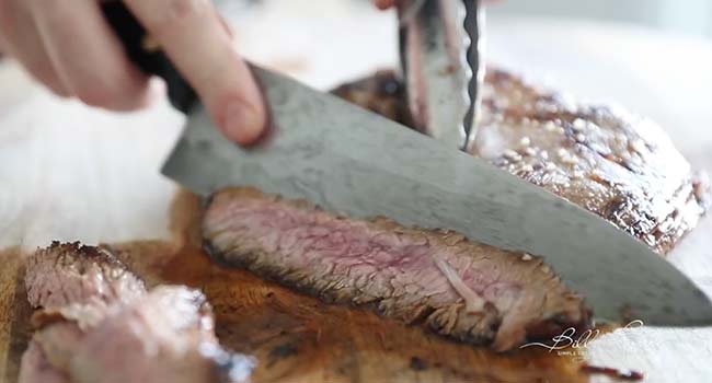 slicing marinated and cooked flanks steak