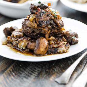 chopped steak burger with onions and mushrooms on a plate