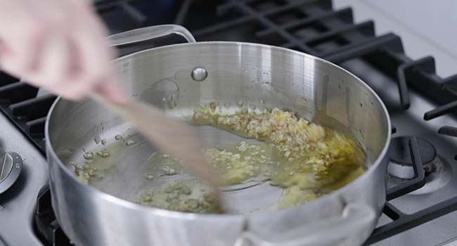 sautéing shallots and garlic in olive oil in a pan