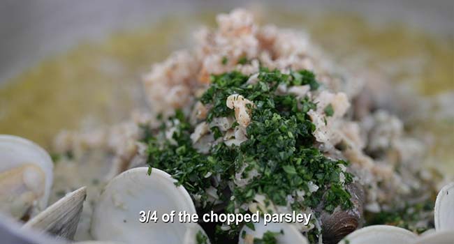 parsley and chopped clams with fresh clams in a pan