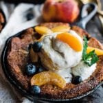 peach cobbler with blueberries and ice cream