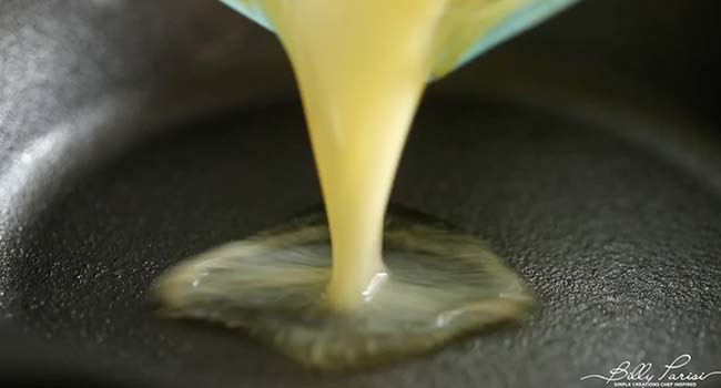 pouring melted butter into a skillet