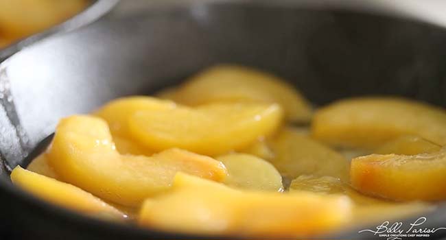 adding peaches to a skillet