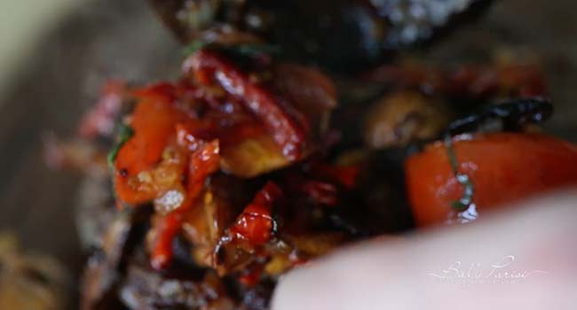 adding a tomato topping to a steak