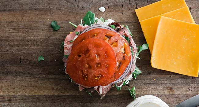 sliced tomatoes on a roast beef sandwich