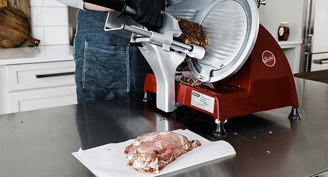 slicing roast beef on a meat slices