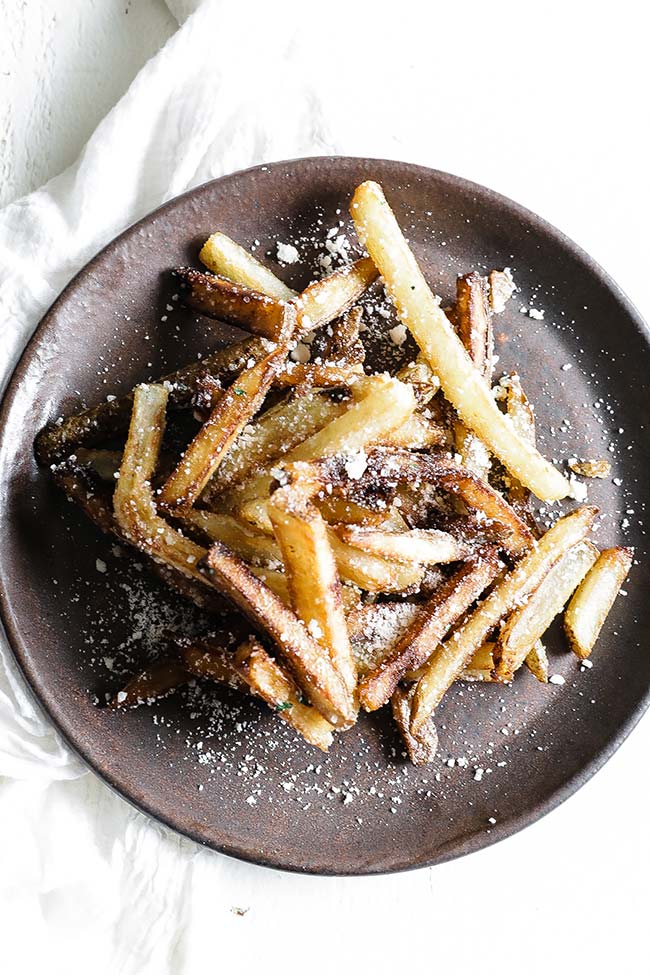 a plate of cooked truffle fries