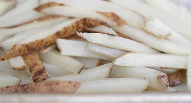 cooked fries on a sheet tray