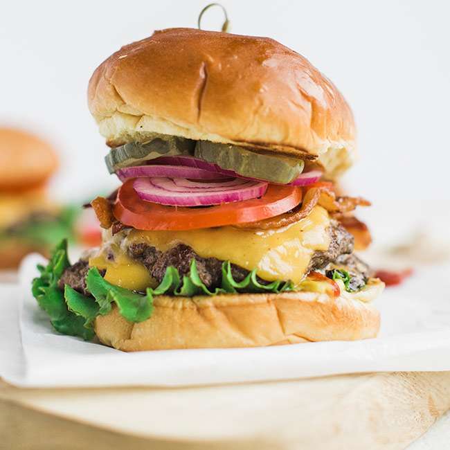 Classic Cheeseburger Recipe on Brioche with Lettuce Tomato and Onions