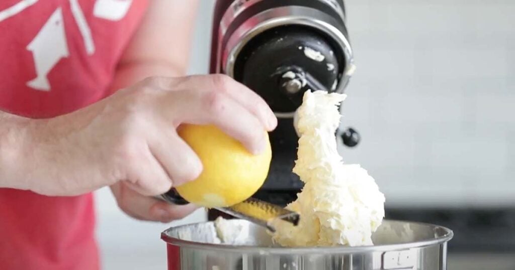 adding lemon zest to a mixer with butter