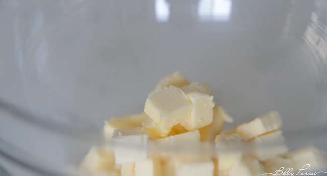 adding butter to a bowl