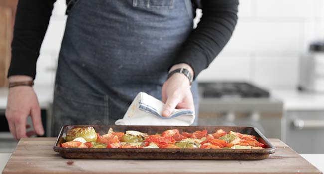 sheet tray of roasted tomatoes, tomatillos and onions