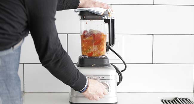 blending roasted vegetables in a blender