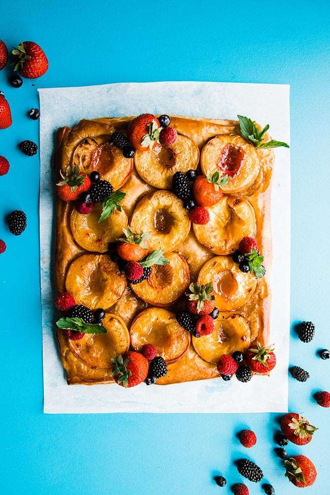 peach tart with homemade puff pastry served on parchment