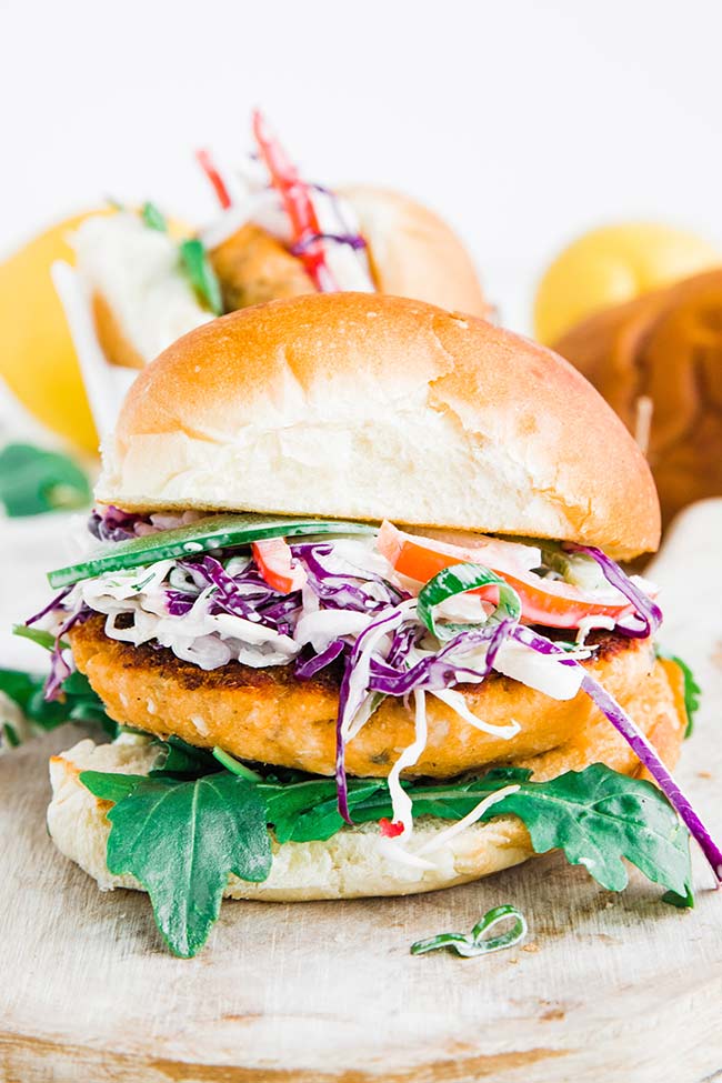 salmon burger with coleslaw and arugula