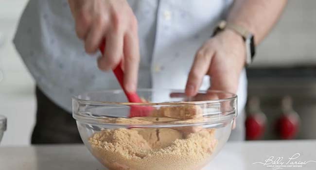 mixing together ground salmon and breadcrumbs