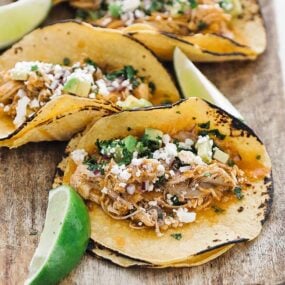 corn tortilla with shredded chicken, cheese and lime