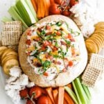 blt dip in a bread bowl with dippers