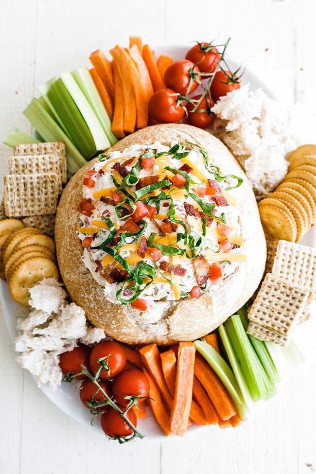 blt dip in a bread bowl with dippers