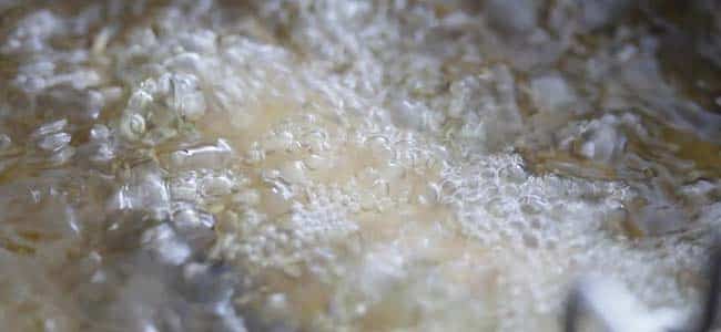 battered fish frying in hot oil