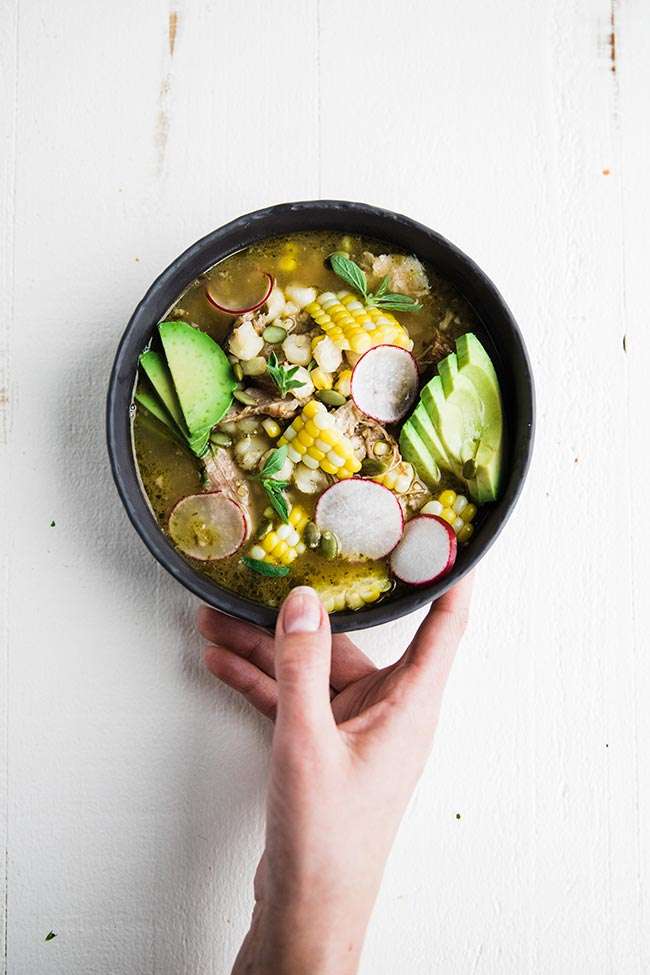 pork pozole soup in a bowl with radishes and avocado