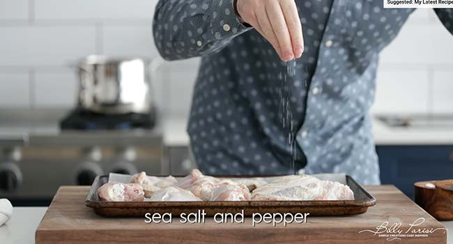 seasoning chicken with salt and pepper