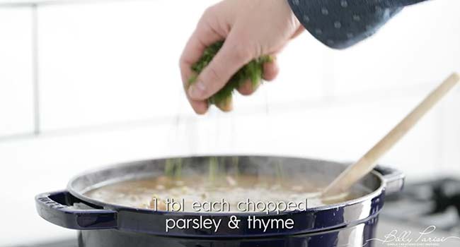 garnishing a ham and lentil soup