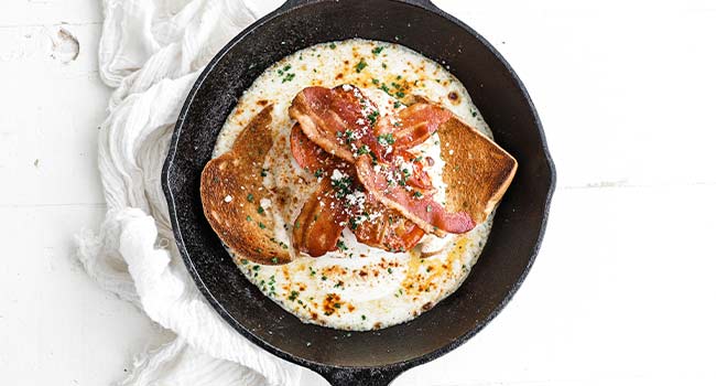 garnishing a hot brown paprika and parsley