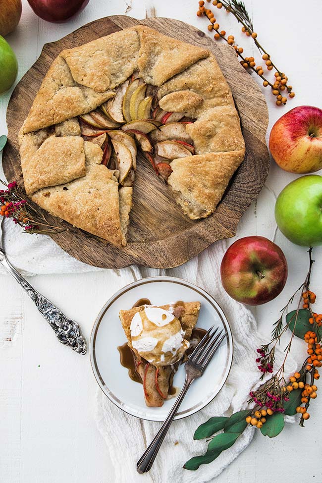 a whole apple galette and a slice with ice cream and caramel