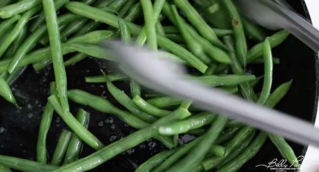 coating cooked green beans in butter