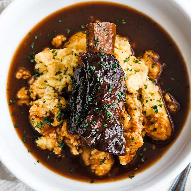 braised short rib with gravy over polenta