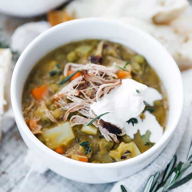 bowl of pea soup with shredded pork and creme fraiche