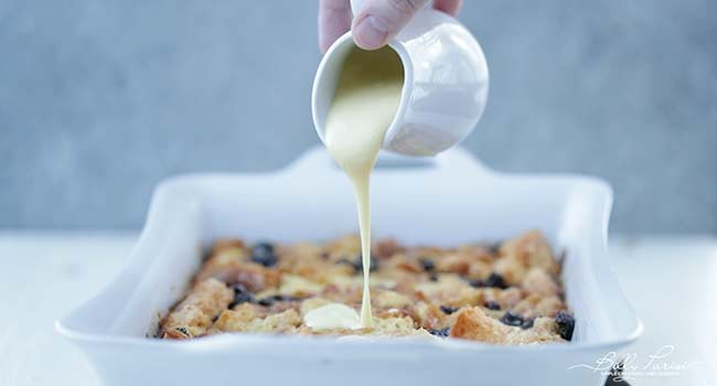 pouring zabaglione on bread pudding