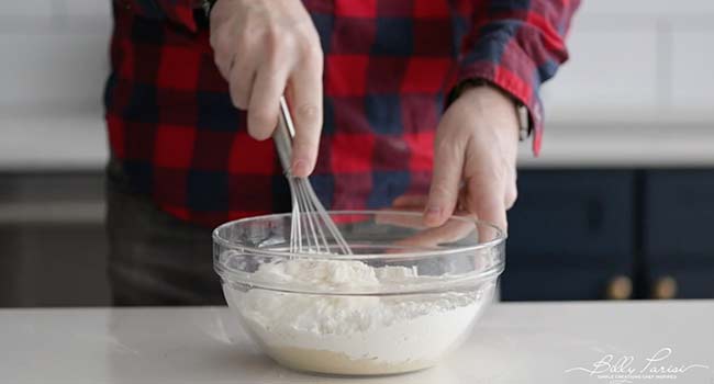 whisking dry ingredients in a bowl