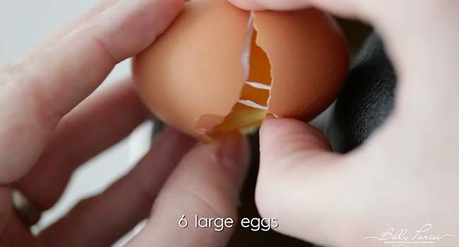 adding eggs to a stand mixer