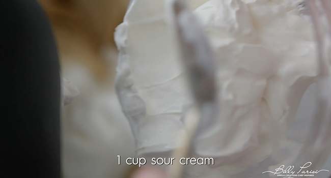 adding sour cream to a mixer